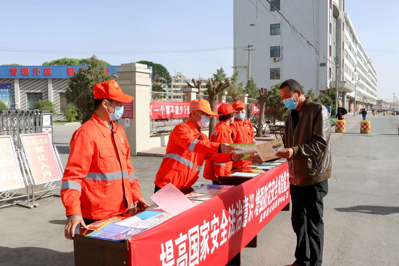 志愿者在单位门口向社会公众发放国家安全教育传单。孙国燕 摄.jpg